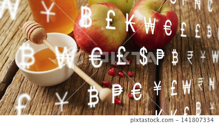 Showing 3 red-green apples bowl jar dipper pomegranate seeds on rustic table, overlaid currency 141807334