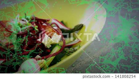 Showing yellow bowl with asparagus, cucumber, feta, red spirals on gray counter, green overlay Showing yellow bowl with asparagus, cucumber, feta, red spirals on gray counter, green overlay 141808254