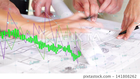 Annotating colleagues in sleeves marking blueprints with pen in studio, showing digital charts Annotating colleagues in sleeves marking blueprints with pen in studio, showing digital charts 141808262