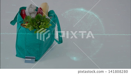 Sitting teal grocery bag holding baguette, card on studio table with data globe overlay, copy space Sitting teal grocery bag holding baguette, card on studio table with data globe overlay, copy space 141808280