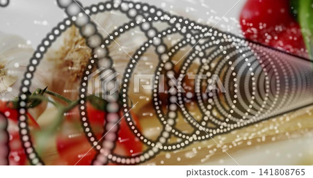 Featuring dotted spiral stretching across wood board, with garlic cloves, cherry tomatoes, droplets 141808765