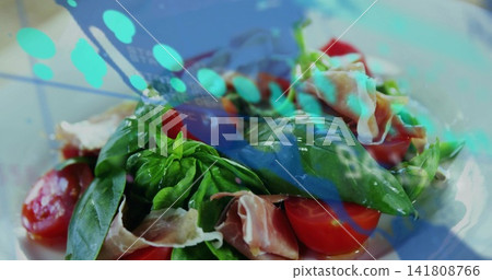 Filling closeup salad sitting on white plate showing basil, tomatoes, prosciutto, turquoise overlay Filling closeup salad sitting on white plate showing basil, tomatoes, prosciutto, turquoise overlay 141808766