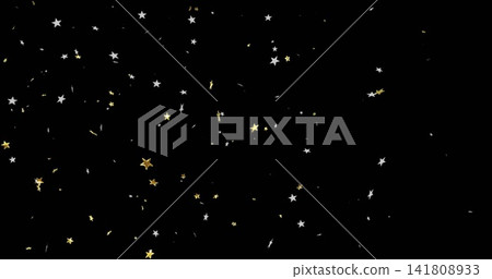 Shimmering gold five-point and silver five-point star confetti drifting on black field with glitter Shimmering gold five-point and silver five-point star confetti drifting on black field with glitter 141808933
