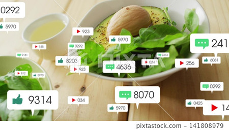 Showing ceramic bowl with halved avocado and greens on wood table, displaying social-media overlays Showing ceramic bowl with halved avocado and greens on wood table, displaying social-media overlays 141808979