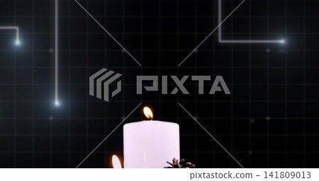 Burning white pillar candles showing visible flames on studio table, pinecones and tech backdrop Burning white pillar candles showing visible flames on studio table, pinecones and tech backdrop 141809013