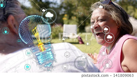 Laughing senior woman wearing pink top, shades, chatting on lawn by chair bulb icons, copy space Laughing senior woman wearing pink top, shades, chatting on lawn by chair bulb icons, copy space 141809063