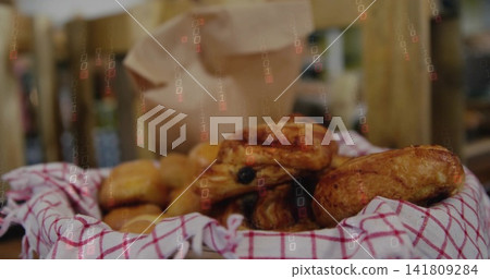 Displaying woven basket holding golden pastries on bakery counter with checked towel and paper bag Displaying woven basket holding golden pastries on bakery counter with checked towel and paper bag 141809284