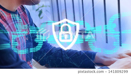 Typing plaid-shirted Chinese man pressing keys at desk, with laptop and security shield, copy space Typing plaid-shirted Chinese man pressing keys at desk, with laptop and security shield, copy space 141809299