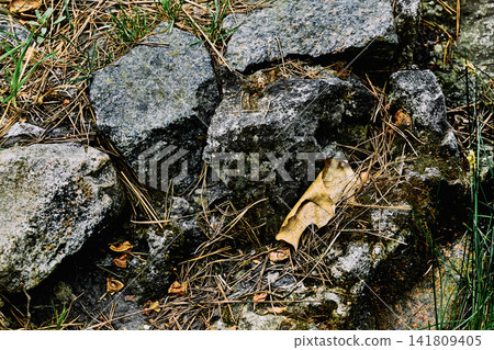 Old aged destroyed granite wall made of stones Old aged destroyed granite wall made of stones 141809405
