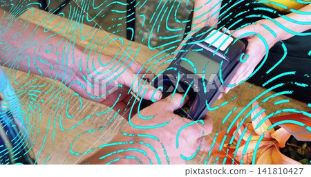Buyer tapping card, clerk in black trim holding terminal over counter with lilies turquoise overlay Buyer tapping card, clerk in black trim holding terminal over counter with lilies turquoise overlay 141810427