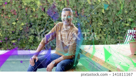 Sitting man wearing brown pullover and blue jeans on wooden bench by pool, with holographic overlay Sitting man wearing brown pullover and blue jeans on wooden bench by pool, with holographic overlay 141811167