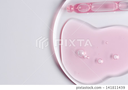 Pink cosmetic product for skin care. A serum or body gel or a moisturizer. Copy space Pink cosmetic product for skin care. A serum or body gel or a moisturizer. Copy space 141811439