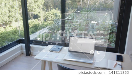 Displaying open silver laptop with holographic calendar overlay in home office, near glass window Displaying open silver laptop with holographic calendar overlay in home office, near glass window 141811863