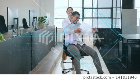 Pushing woman coworker moving seated man on rolling chair down aisle with papers, biz-casual HUD Pushing woman coworker moving seated man on rolling chair down aisle with papers, biz-casual HUD 141811946