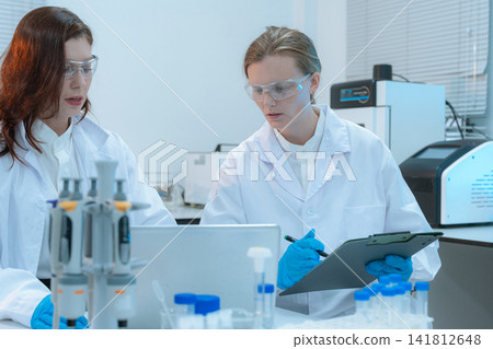 Scientist researching plant extracts for antiviral and virus prevention. 141812648