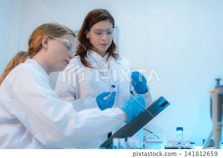 Scientist researching plant extracts for antiviral and virus prevention. 141812659