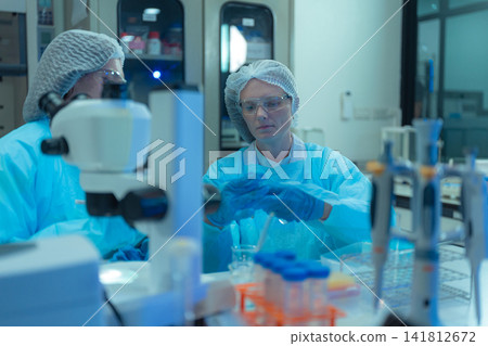 Scientist researching plant extracts for antiviral and virus prevention. 141812672