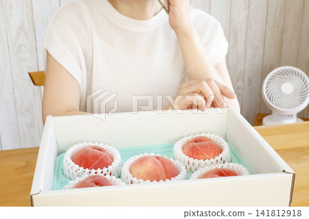 A woman calls to thank them for the peaches she received as a summer fruit gift. A woman calls to thank them for the peaches she received as a summer fruit gift. 141812918