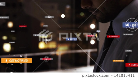 Studying Asian man in white shirt and striped tie watching tablet with social overlays, copy space Studying Asian man in white shirt and striped tie watching tablet with social overlays, copy space 141813411