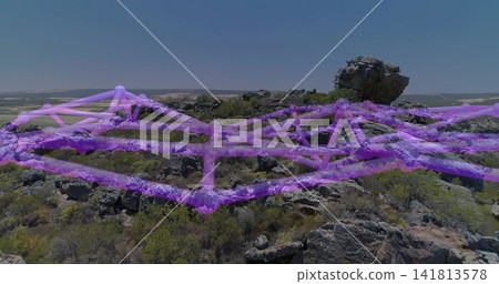 Displaying rocky plateau featuring perched boulder and purple mesh draping over terrain Displaying rocky plateau featuring perched boulder and purple mesh draping over terrain 141813578