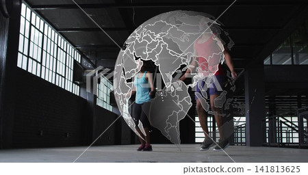 Skipping two exercisers jumping rope inside warehouse with globe overlay, wearing athletic shoes 141813625