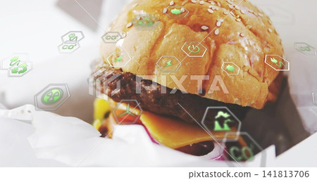 Showing wrapped sesame-topped cheeseburger sitting on counter, with patty, melted cheddar eco icons Showing wrapped sesame-topped cheeseburger sitting on counter, with patty, melted cheddar eco icons 141813706