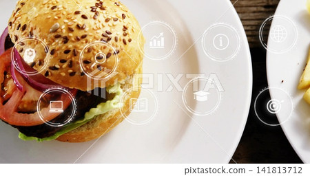 Showing sesame bun burger sitting on dark wooden table with UI icons, copy space Showing sesame bun burger sitting on dark wooden table with UI icons, copy space 141813712