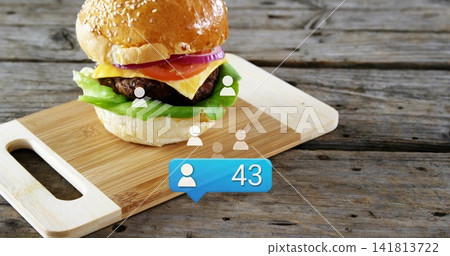 Showcasing sesame bun burger with onion tomato cheese lettuce on wood board with avatars showing 43 Showcasing sesame bun burger with onion tomato cheese lettuce on wood board with avatars showing 43 141813722