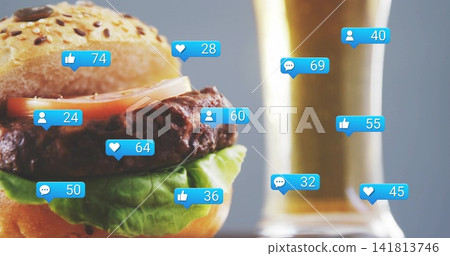 Displaying seeded bun with tomato, grilled patty, lettuce in studio with beer glass, blue bubbles Displaying seeded bun with tomato, grilled patty, lettuce in studio with beer glass, blue bubbles 141813746