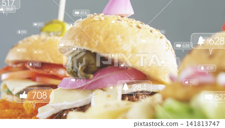 Displaying sesame-seed slider showing cheese, patty, pickled pepper on gray table, social overlays Displaying sesame-seed slider showing cheese, patty, pickled pepper on gray table, social overlays 141813747