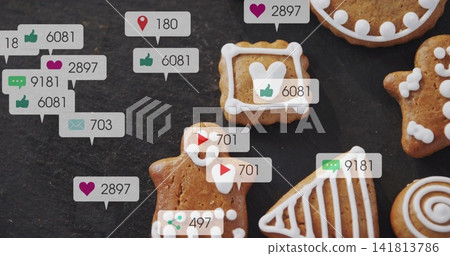 White-iced gingerbread cookies lying on dark slate, showing floating bubbles with icons and counts White-iced gingerbread cookies lying on dark slate, showing floating bubbles with icons and counts 141813786