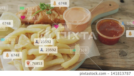 Showing paddle holding French fries, fried fish, lemon wedge, two sauces on wooden table, icons Showing paddle holding French fries, fried fish, lemon wedge, two sauces on wooden table, icons 141813787