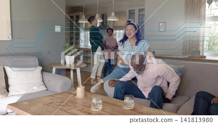 Smiling woman in striped blouse sitting on sofa arm, chatting in open home with blue overlay Smiling woman in striped blouse sitting on sofa arm, chatting in open home with blue overlay 141813980