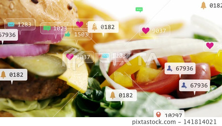 Displaying cheeseburger and fresh salad on tabletop, overlaying social media notification icons Displaying cheeseburger and fresh salad on tabletop, overlaying social media notification icons 141814021