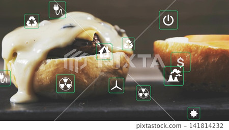 Showing cheeseburger with melted cheese oozing toasted bun and patty on dark table with green icons Showing cheeseburger with melted cheese oozing toasted bun and patty on dark table with green icons 141814232