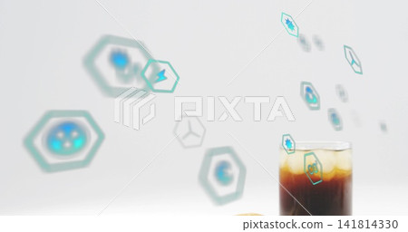 Showing glass holding iced coffee, amber-top, cookie, teal hexagons on studio tabletop, copy space Showing glass holding iced coffee, amber-top, cookie, teal hexagons on studio tabletop, copy space 141814330