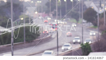 Moving sedans creating light streaks on suburban highway curve at dusk, with white dotted waveform Moving sedans creating light streaks on suburban highway curve at dusk, with white dotted waveform 141814867