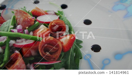 Displaying salad on white plate with arugula, strawberries, prosciutto, balsamic glaze, copy space Displaying salad on white plate with arugula, strawberries, prosciutto, balsamic glaze, copy space 141814961