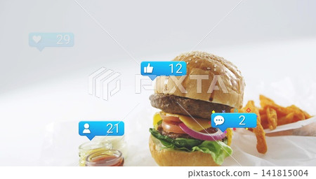Showcasing stacked cheeseburger on white paper at studio, with fries, glass jars, reaction badges Showcasing stacked cheeseburger on white paper at studio, with fries, glass jars, reaction badges 141815004