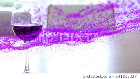 Showing stemmed glass holding dark red wine reflecting on kitchen table, purple streak, copy space 141815327