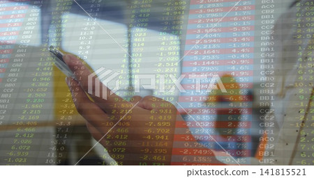 Holding single hand with orange sleeve, viewing smartphone in train, with stock data overlay Holding single hand with orange sleeve, viewing smartphone in train, with stock data overlay 141815521