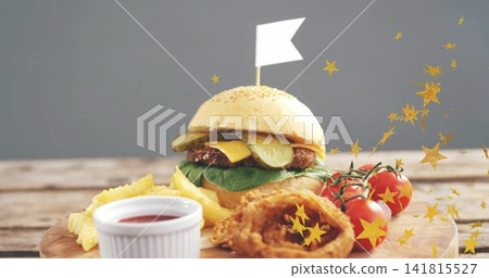 Showing sesame cheeseburger with beef patty melting cheese, pickles, lettuce on board, fries, flag Showing sesame cheeseburger with beef patty melting cheese, pickles, lettuce on board, fries, flag 141815527