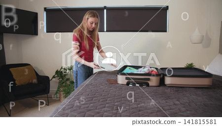 Packing woman in red top and jeans loading open suitcase in bedroom, digital overlay, copy space Packing woman in red top and jeans loading open suitcase in bedroom, digital overlay, copy space 141815581