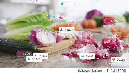 Displaying halved red onion and cucumber on wooden board at kitchen counter, with social icons Displaying halved red onion and cucumber on wooden board at kitchen counter, with social icons 141815608