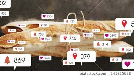 Displaying three crusty baguettes tied with twine on dark board, showing heart, pin, bell badges Displaying three crusty baguettes tied with twine on dark board, showing heart, pin, bell badges 141815658