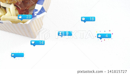 Showing takeout box holding sesame burger and fries on white studio, with blue bubbles, copy space Showing takeout box holding sesame burger and fries on white studio, with blue bubbles, copy space 141815727