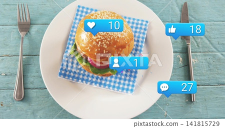 Showing sesame burger on white plate at turquoise table, with gingham napkin, cutlery, blue bubbles Showing sesame burger on white plate at turquoise table, with gingham napkin, cutlery, blue bubbles 141815729