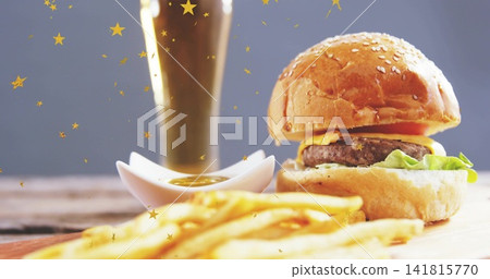 Showing sesame burger melting cheddar on board at studio, with fries, sauce, gold stars, copy space Showing sesame burger melting cheddar on board at studio, with fries, sauce, gold stars, copy space 141815770