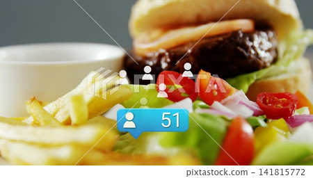Showing burger with beef-patty, fries and salad on table, with blue '51' bubble and white-icons Showing burger with beef-patty, fries and salad on table, with blue '51' bubble and white-icons 141815772