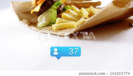 Displaying burger and fries on white tabletop with crumpled paper, three grey icons, blue 37 bubble Displaying burger and fries on white tabletop with crumpled paper, three grey icons, blue 37 bubble 141815774